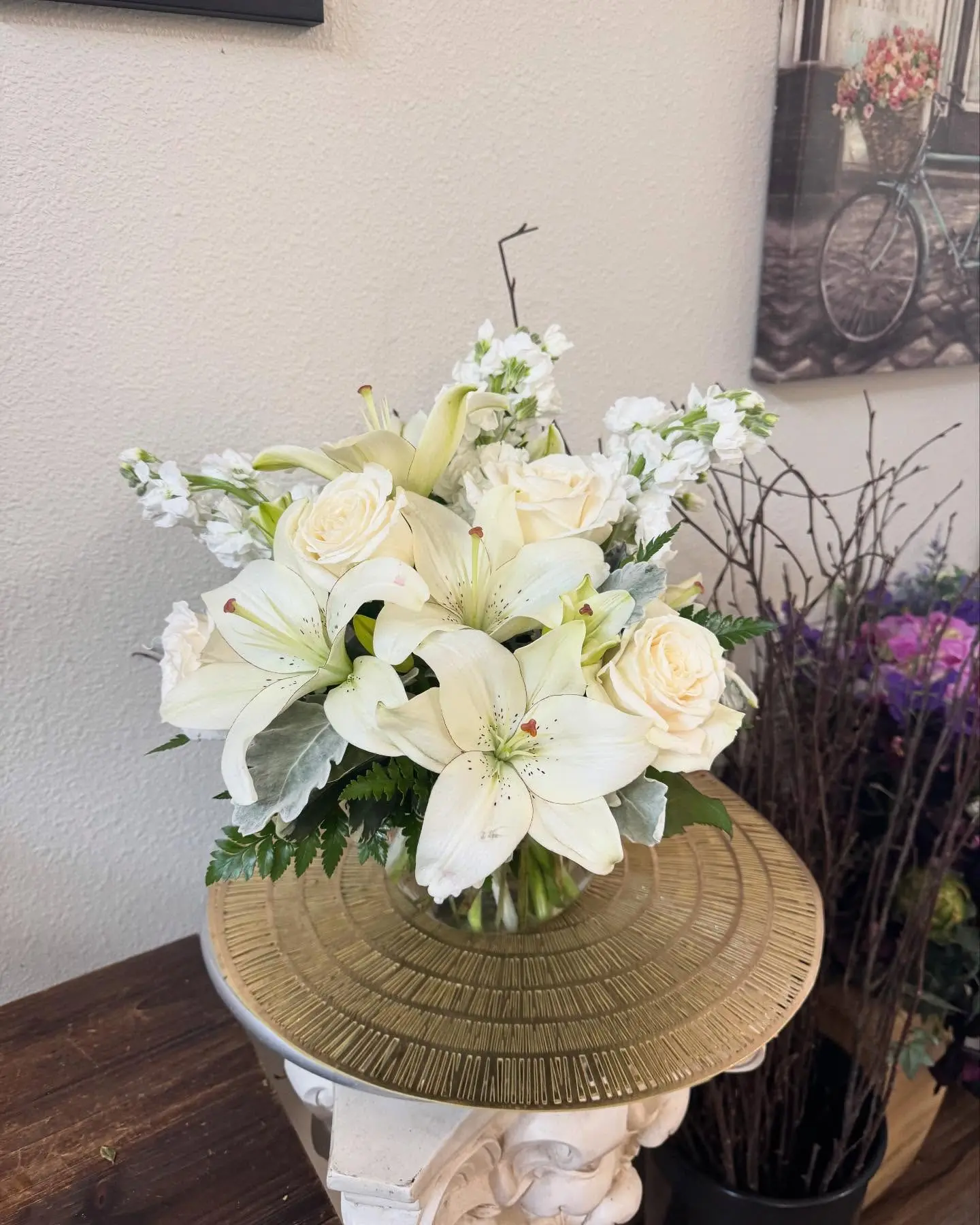White lilies and cream roses arranged in a vase